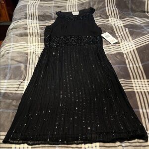 Beaded black cocktail dress by Stenay.
NWT